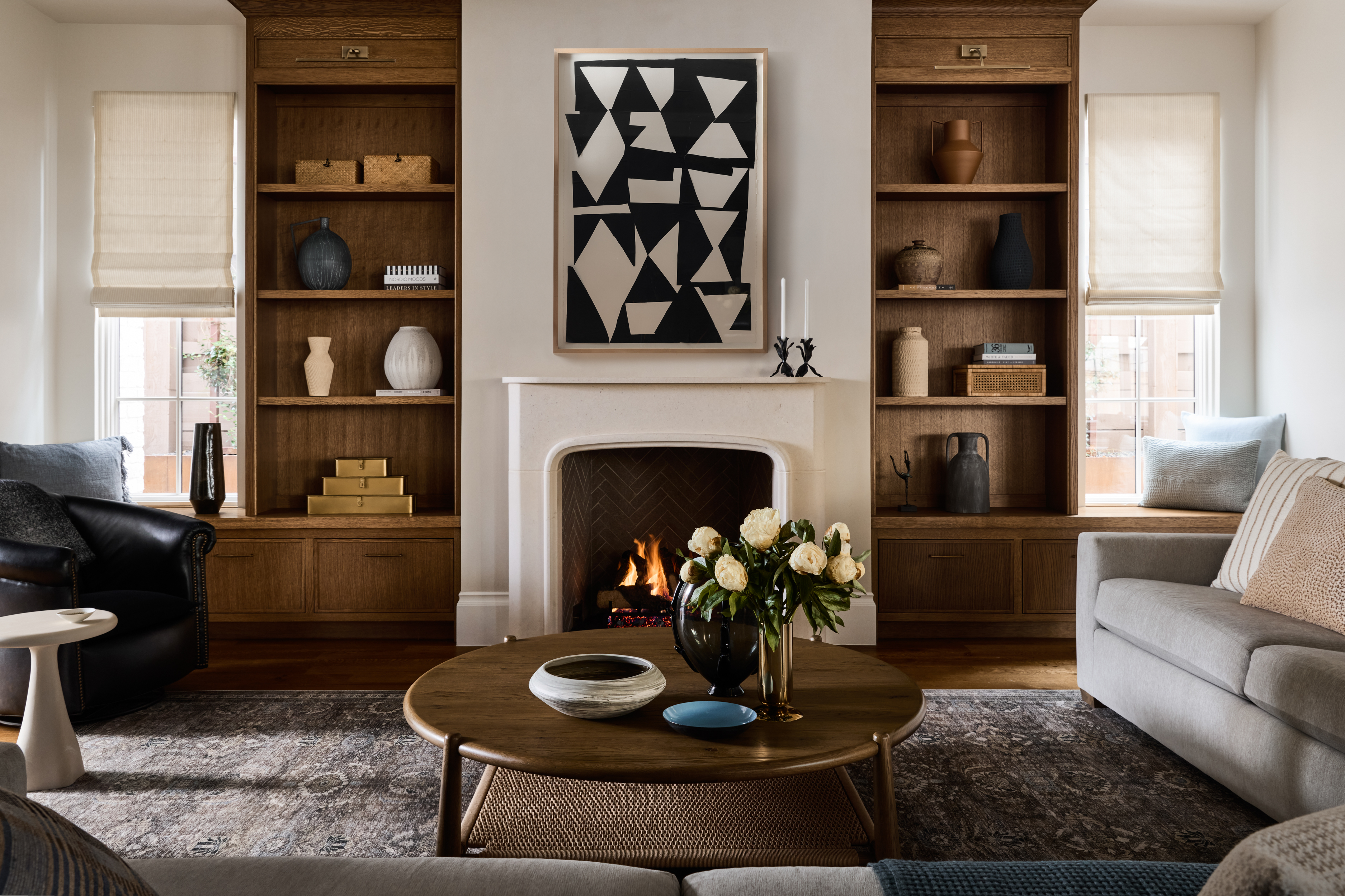 Living room with custom oak shelving and limestone fireplace