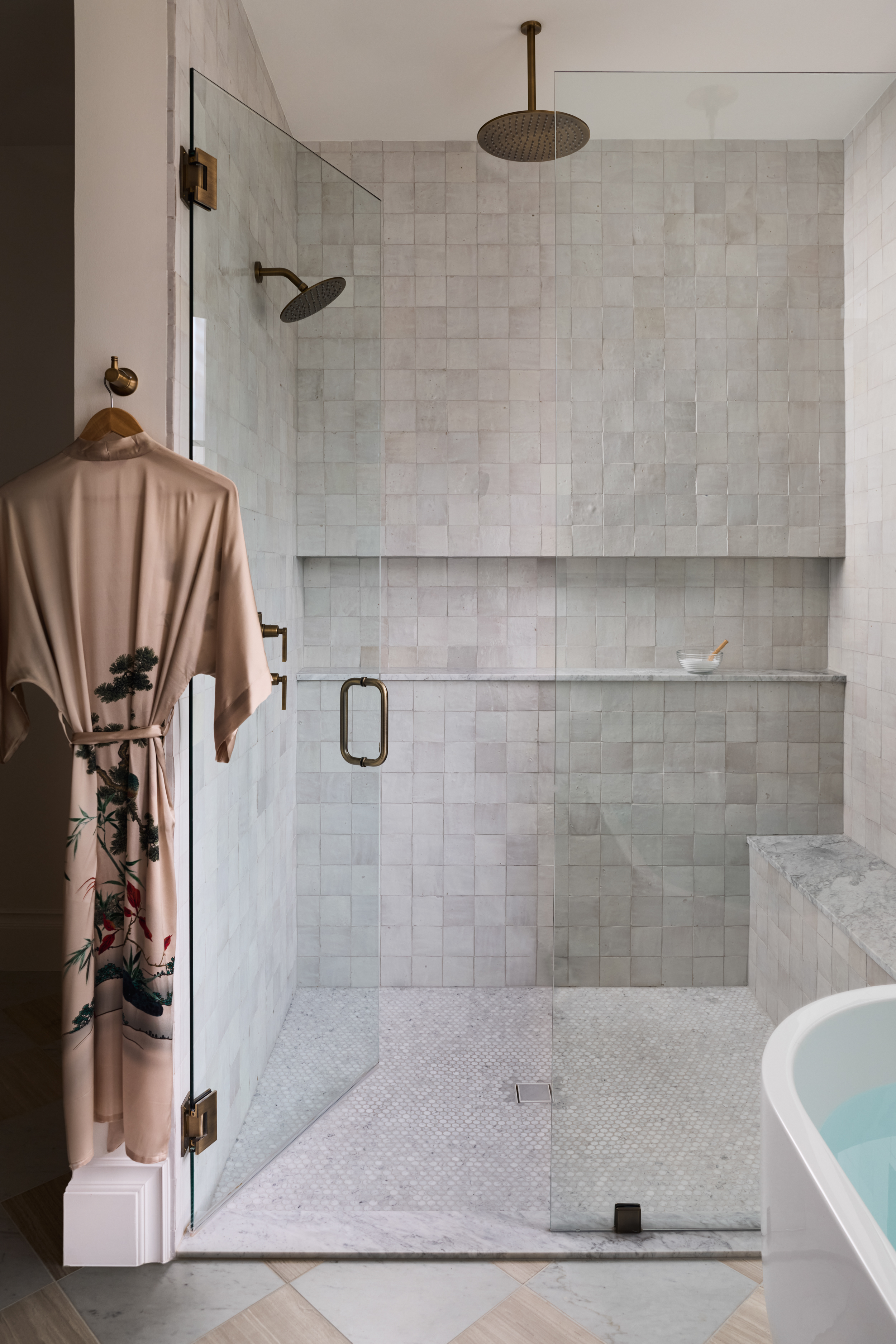 Walk-in shower lined in softly varied handmade tile